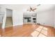 Bright living room with beautiful wood floors connecting to an eat-in kitchen at 4448 Riverton Dr, Orlando, FL 32817