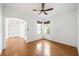 Cozy living room with hardwood floors, windows, and a ceiling fan at 4448 Riverton Dr, Orlando, FL 32817