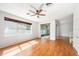 Sunlit living room featuring wood flooring and a sliding glass door at 4448 Riverton Dr, Orlando, FL 32817
