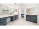 Ensuite bathroom with dual sink vanity, tiled floors, and abundant lighting at 4448 Riverton Dr, Orlando, FL 32817