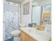 Bathroom featuring a shower with a floral curtain, a sink, and a view into the kitchen at 4541 Southfield Ave, Orlando, FL 32812