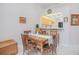 Sunlit dining area features a wooden table, chairs, and a window to the kitchen at 4541 Southfield Ave, Orlando, FL 32812
