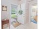 A welcoming foyer with neutral walls, light-colored tile flooring, and a view into the bathroom at 4541 Southfield Ave, Orlando, FL 32812