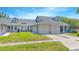 Charming townhome showcasing a well-kept lawn and convenient two-car garage at 4541 Southfield Ave, Orlando, FL 32812
