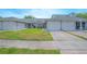 Attractive townhome boasts an attached two-car garage and a tidy front lawn at 4541 Southfield Ave, Orlando, FL 32812