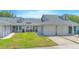 Inviting townhome showcasing well-maintained lawn and a two car garage for comfortable suburban living at 4541 Southfield Ave, Orlando, FL 32812
