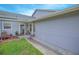 Close up of home showing covered front entry with green grass and gray siding at 4541 Southfield Ave, Orlando, FL 32812