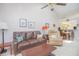 Open concept living room is showcased with tile flooring, furnishings, and views into the kitchen at 4541 Southfield Ave, Orlando, FL 32812