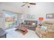 Well lit living area with tile flooring, comfortable furnishings, and a slider overlooking the backyard at 4541 Southfield Ave, Orlando, FL 32812