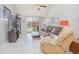 Cozy living room featuring neutral tile flooring and sliding glass doors leading to an outdoor space at 4541 Southfield Ave, Orlando, FL 32812
