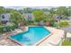 Aerial view of a community pool with lounge chairs and lush landscaping at 4541 Southfield Ave, Orlando, FL 32812