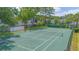 Aerial view of a fenced community tennis court surrounded by trees at 4541 Southfield Ave, Orlando, FL 32812