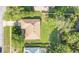 Aerial view of a home showcasing its roof, landscaping, driveway, and proximity to other residences at 477 Eagle Brook Ct, Debary, FL 32713