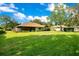 Expansive backyard with lush green grass surrounding the home at 477 Eagle Brook Ct, Debary, FL 32713