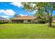 View of the house from the backyard, including a screened porch and well-maintained lawn at 477 Eagle Brook Ct, Debary, FL 32713