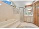 Bathroom featuring tiled walls, a bathtub with shower, and a vanity with ample storage at 477 Eagle Brook Ct, Debary, FL 32713