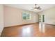 Sunlit bedroom featuring hardwood floors, large window, and access to the outdoor space at 477 Eagle Brook Ct, Debary, FL 32713