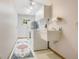 Laundry room featuring a washer, dryer, utility sink and additional storage space at 477 Eagle Brook Ct, Debary, FL 32713