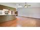 Spacious living room featuring hardwood floors and an open layout to the kitchen area at 477 Eagle Brook Ct, Debary, FL 32713