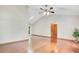 Spacious living room with vaulted ceiling, hardwood floors, and a ceiling fan, creating an airy feel at 477 Eagle Brook Ct, Debary, FL 32713