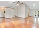 Spacious living room with vaulted ceiling, hardwood floors, and a ceiling fan, creating an airy feel at 477 Eagle Brook Ct, Debary, FL 32713