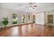 Bright living room featuring gleaming hardwood floors, ceiling fans, and large arched windows at 477 Eagle Brook Ct, Debary, FL 32713