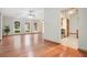 Bright living room featuring gleaming hardwood floors, ceiling fans, and large arched windows at 477 Eagle Brook Ct, Debary, FL 32713