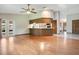 Open floor plan with hardwood floors connecting the living room and kitchen, great for entertaining at 477 Eagle Brook Ct, Debary, FL 32713