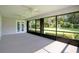 Spacious screened porch with ceiling fans, offering panoramic views of the lush backyard at 477 Eagle Brook Ct, Debary, FL 32713