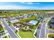 Aerial view of a community with a central pool, playground and green spaces at 4792 Vellacito Way, Davenport, FL 33897