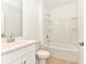 Bright bathroom featuring a tub with shower and single sink vanity with stylish fixtures at 4792 Vellacito Way, Davenport, FL 33897