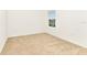 A bright bedroom with neutral carpet and a window at 4792 Vellacito Way, Davenport, FL 33897