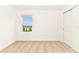 A bright bedroom with neutral carpet, a window, and a closet at 4792 Vellacito Way, Davenport, FL 33897