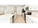 Modern kitchen with white cabinets, stainless steel appliances, and a central island perfect for entertaining at 4792 Vellacito Way, Davenport, FL 33897