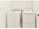 The laundry room features a washer, dryer, and shelving at 4792 Vellacito Way, Davenport, FL 33897