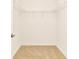 A walk-in closet featuring carpeted floors and built-in shelving units at 4792 Vellacito Way, Davenport, FL 33897