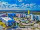 Aerial view of a vibrant condo community with landscaped grounds, a tennis court, and ample parking at 5 Riverwalk Dr # 601, New Smyrna Beach, FL 32169