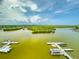Breathtaking aerial view of the intercoastal waterway with mangrove islands, docks, and boats under a blue, cloudy sky at 5 Riverwalk Dr # 601, New Smyrna Beach, FL 32169