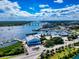 Aerial view of a coastal community featuring a marina, bridge, and waterways under a blue sky at 5 Riverwalk Dr # 601, New Smyrna Beach, FL 32169