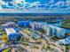 Aerial view of colorful condos, the well-maintained tennis courts and the community's beautiful location on the water at 5 Riverwalk Dr # 601, New Smyrna Beach, FL 32169