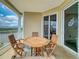 Outdoor seating area on the balcony with views of the water and sliding glass doors to the interior at 5 Riverwalk Dr # 601, New Smyrna Beach, FL 32169