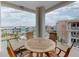 Balcony with outdoor table and chairs overlooking colorful buildings and manicured landscaping at 5 Riverwalk Dr # 601, New Smyrna Beach, FL 32169