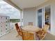 Balcony with wooden table and chairs with a view of the water and surrounding buildings at 5 Riverwalk Dr # 601, New Smyrna Beach, FL 32169