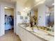 Bathroom with granite counters, double sinks, tile flooring, walk-in shower and walk-in closet at 5 Riverwalk Dr # 601, New Smyrna Beach, FL 32169