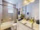 Bathroom featuring a shower and tub combination, vanity with granite counters, and tiled walls at 5 Riverwalk Dr # 601, New Smyrna Beach, FL 32169