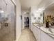 Bathroom with granite counters, walk-in shower, tile flooring, and a walk-in closet at 5 Riverwalk Dr # 601, New Smyrna Beach, FL 32169