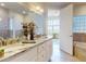Bathroom with granite counters, double sinks, tile flooring, walk-in shower, tub, and windows at 5 Riverwalk Dr # 601, New Smyrna Beach, FL 32169
