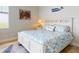 Bright bedroom with coastal decor, white furniture, and a window with a water view at 5 Riverwalk Dr # 601, New Smyrna Beach, FL 32169