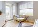 Bedroom with a balcony, large windows, and chaise lounge seating at 5 Riverwalk Dr # 601, New Smyrna Beach, FL 32169