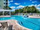 Community pool with beautiful water feature and plenty of chairs and tables for relaxing by the poolside at 5 Riverwalk Dr # 601, New Smyrna Beach, FL 32169